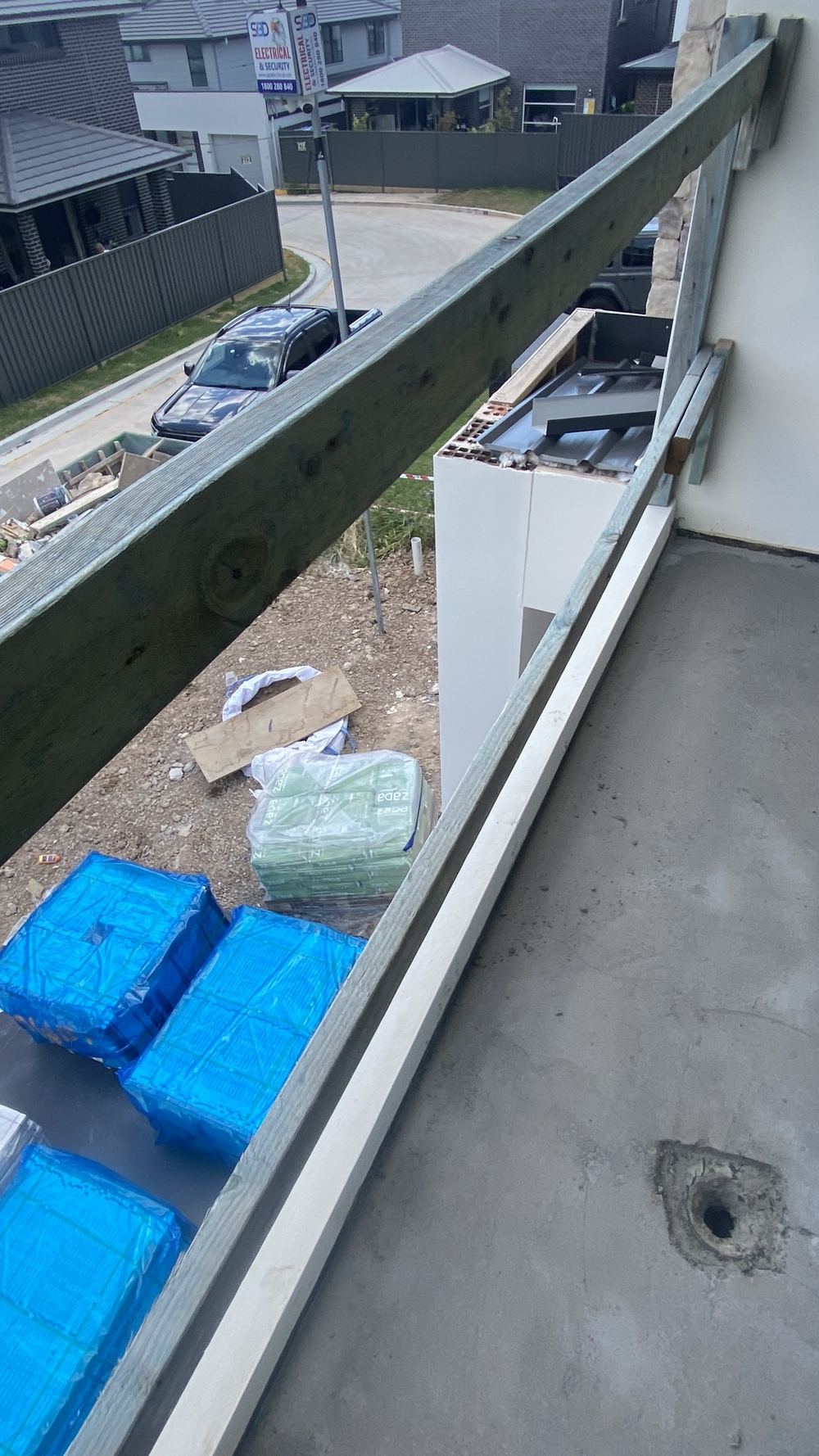 Balcony without its handrails, a fall hazard until they are fitted, Tallawong