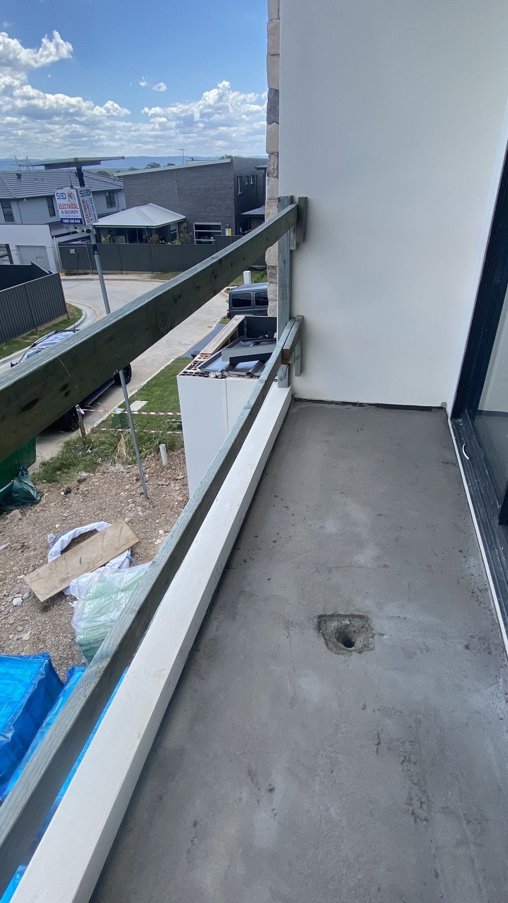 Balcony built with no overflow, so one blocked drain floods the door sill, found during a defect investigation in Tallawong