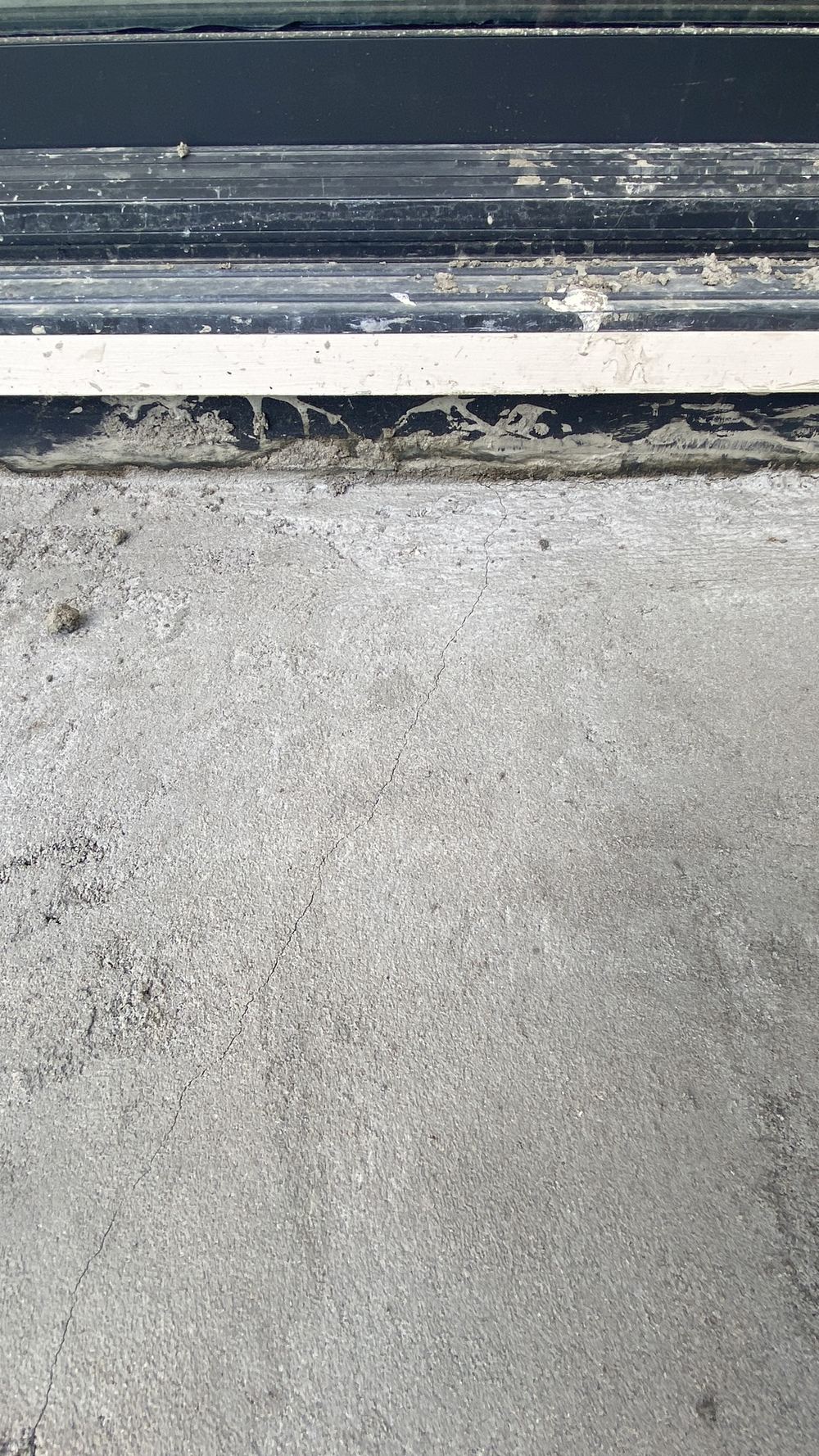 Cracking through the bedding screed under the balcony tiles, found during a defect investigation in Tallawong