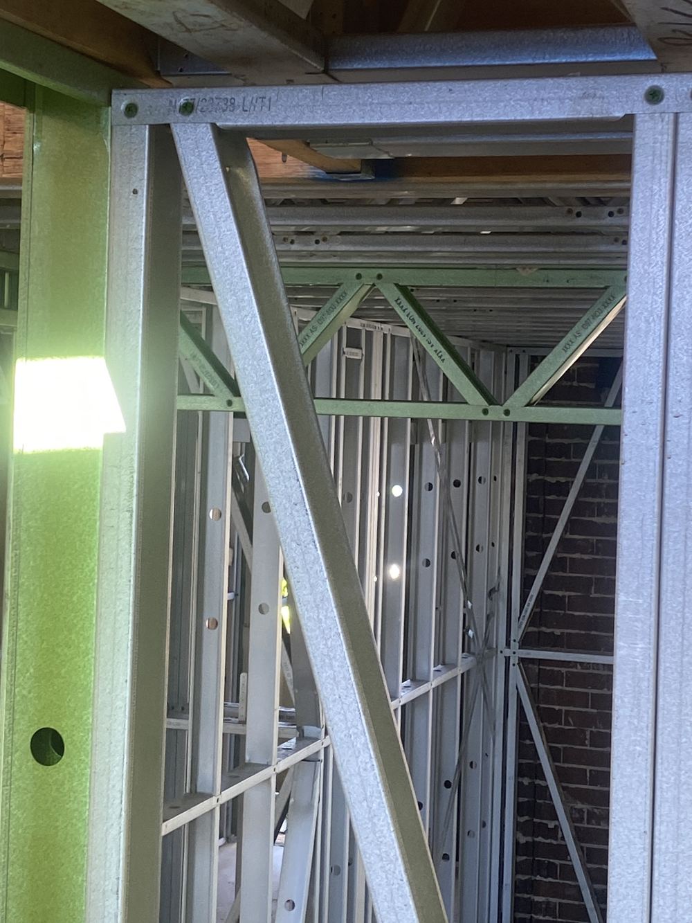 Beam not seated fully into its hanger and needing a packer, found during a frame inspection in Carlingford