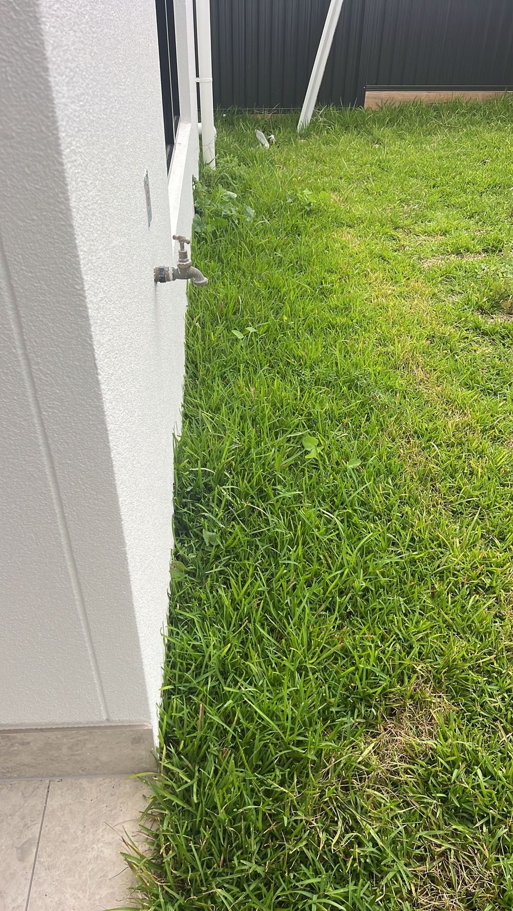 Ground not yet shaped to drain rainwater away from the slab, found during a handover inspection in Tallawong