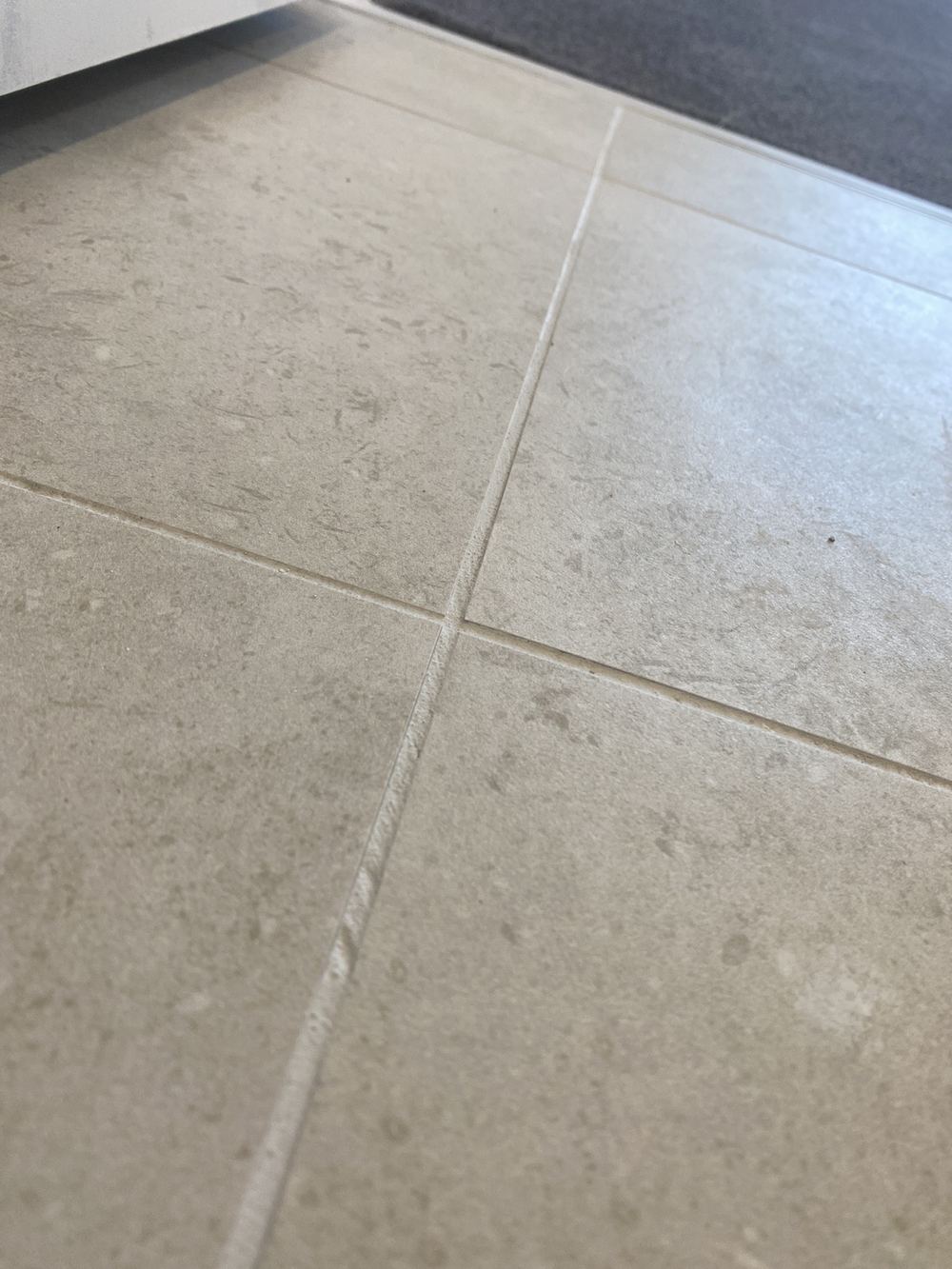 Patchy grout and joint finish in the ensuite tiling, Tallawong